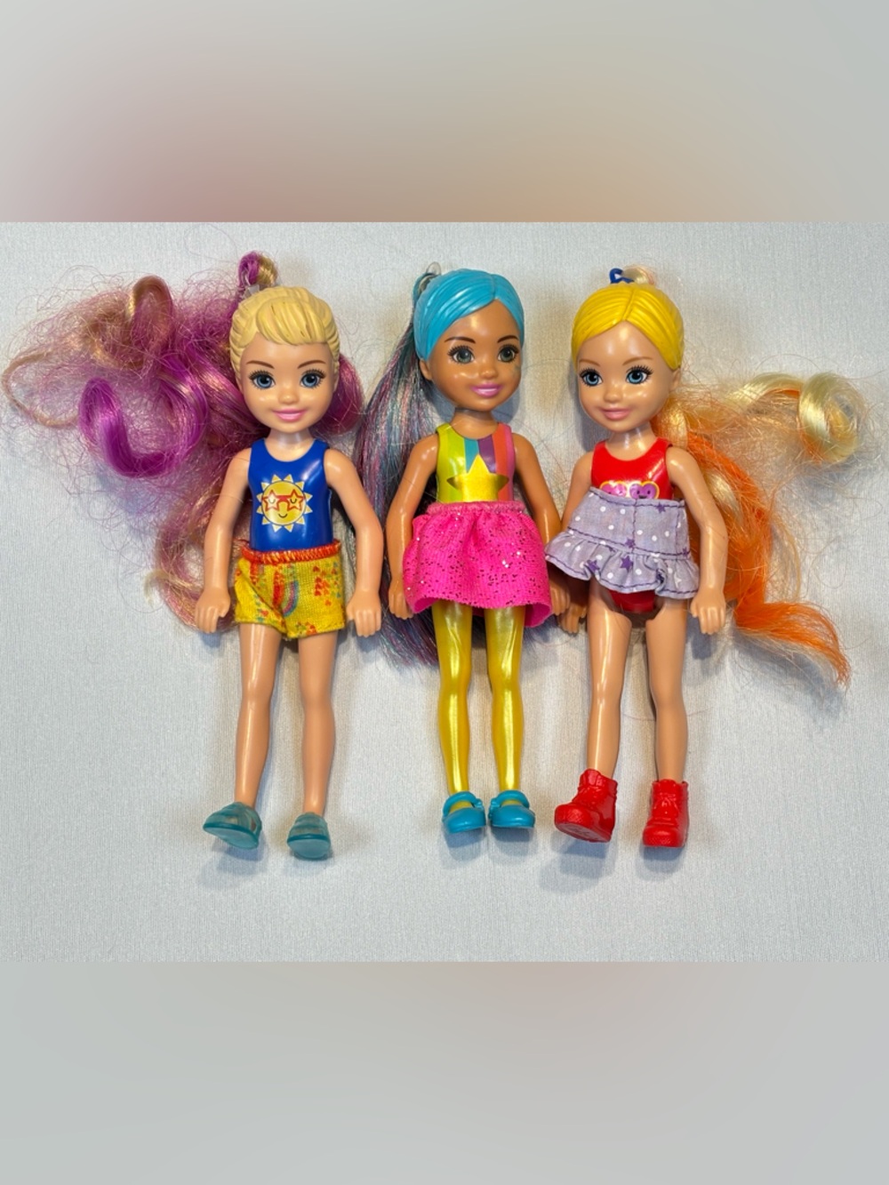 Three Chelsea Barbie dolls